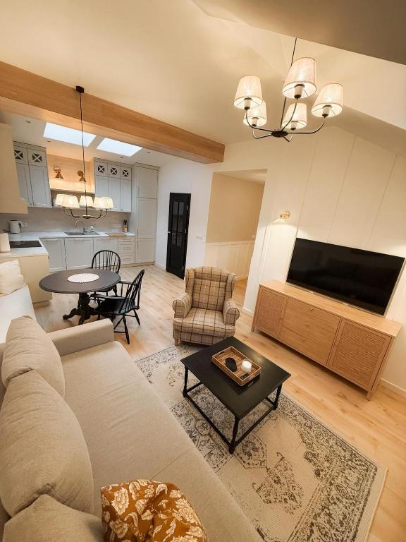 a living room with a couch and a table at Apartamenty Guzik 32 in Krosno