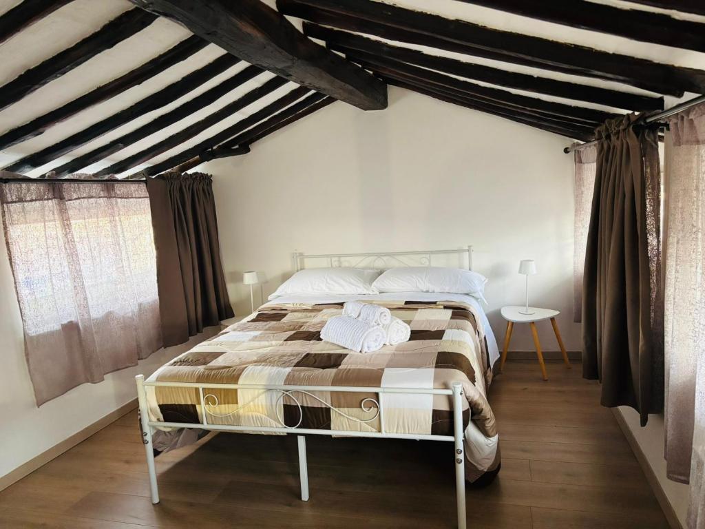 a bedroom with a large bed in a room at Alloggio Turistico LA TORRE in Acquapendente