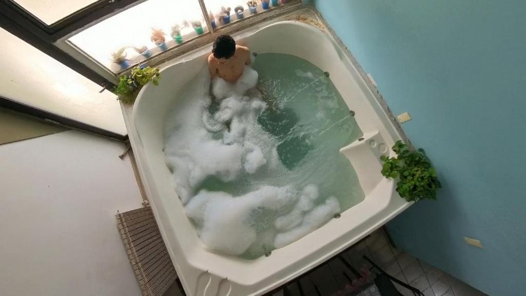 a man in a bath tub with clouds in it at Mary Elena in La Porteña
