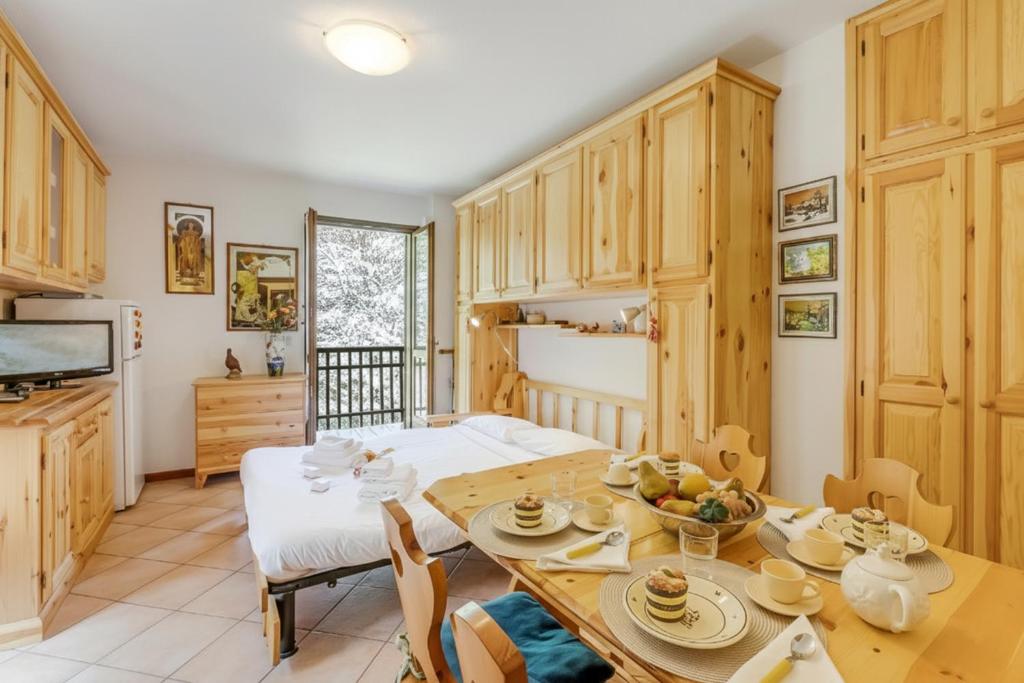 a kitchen and dining room with a table and chairs at Relax In Pineta - Happy Rentals in Oulx