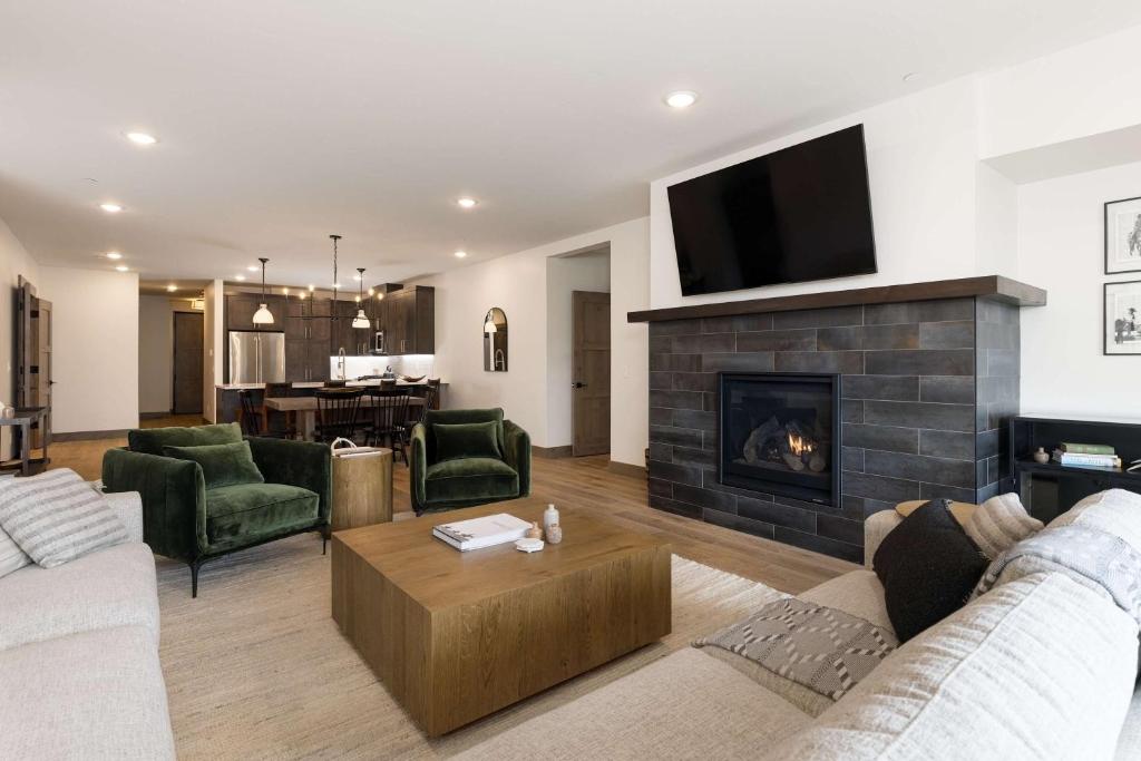 Una sala de estar con un sofá y una chimenea. en Big Sky Base Camp Fireplace Views & Hot Tub, en Big Sky Mountain Village