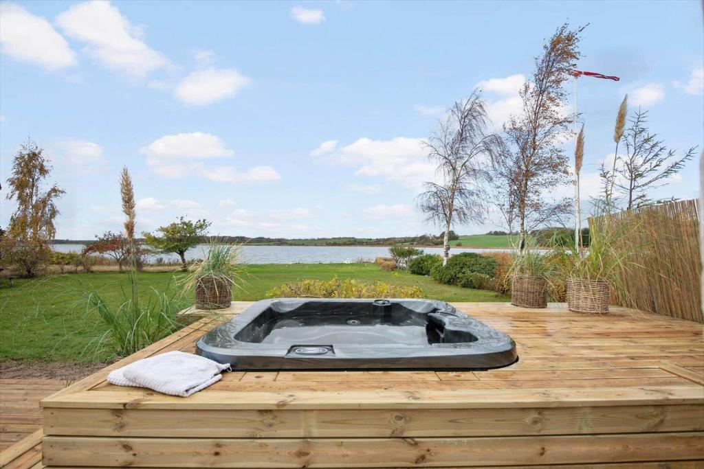 a hot tub sitting on top of a wooden deck at 30194-Malling-Fjordvej-26 in Norsminde