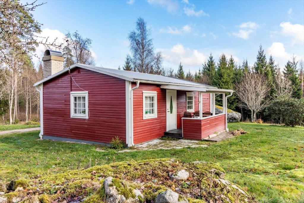 a small red and white house in a field at KRO802-Haeradsbaeck-Ellagoelshult-3 in Gäddegölshult
