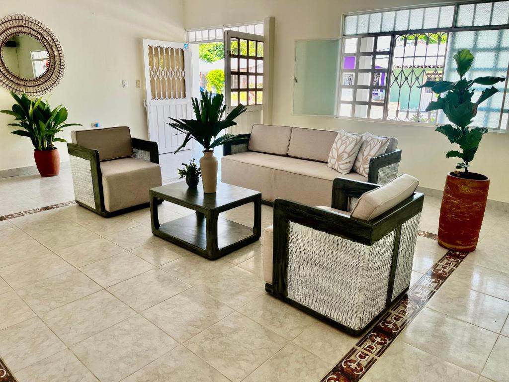 a living room with a couch and chairs and a table at Hotel brisas del opía in Piedras