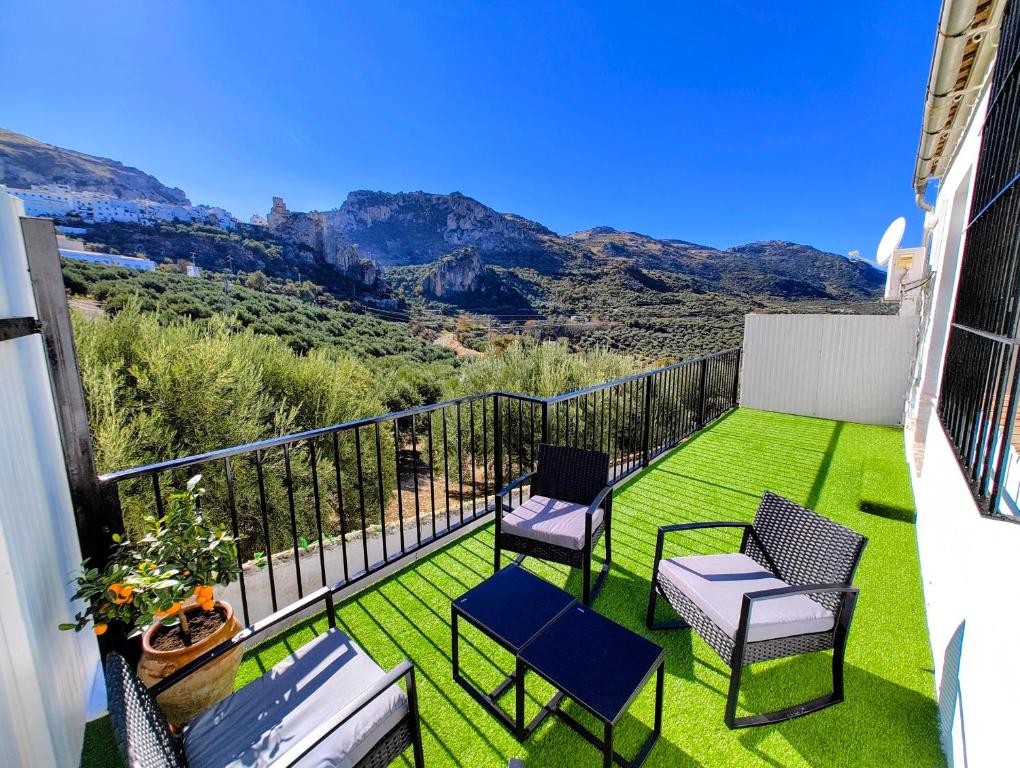a balcony with chairs and a view of the mountains at Alojamiento La Nave de Zuheros in Zuheros