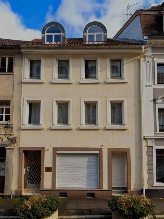 a large white building with windows and a roof at Appartements Frank in Baden-Baden