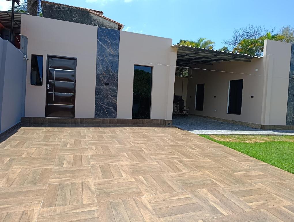 a house with a wooden floor in front of it at Depto completo de 1 dormitorio en CDE Area 4 in Ciudad del Este