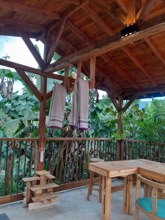 a wooden pavilion with a table and benches at Fresh Start in Jardin