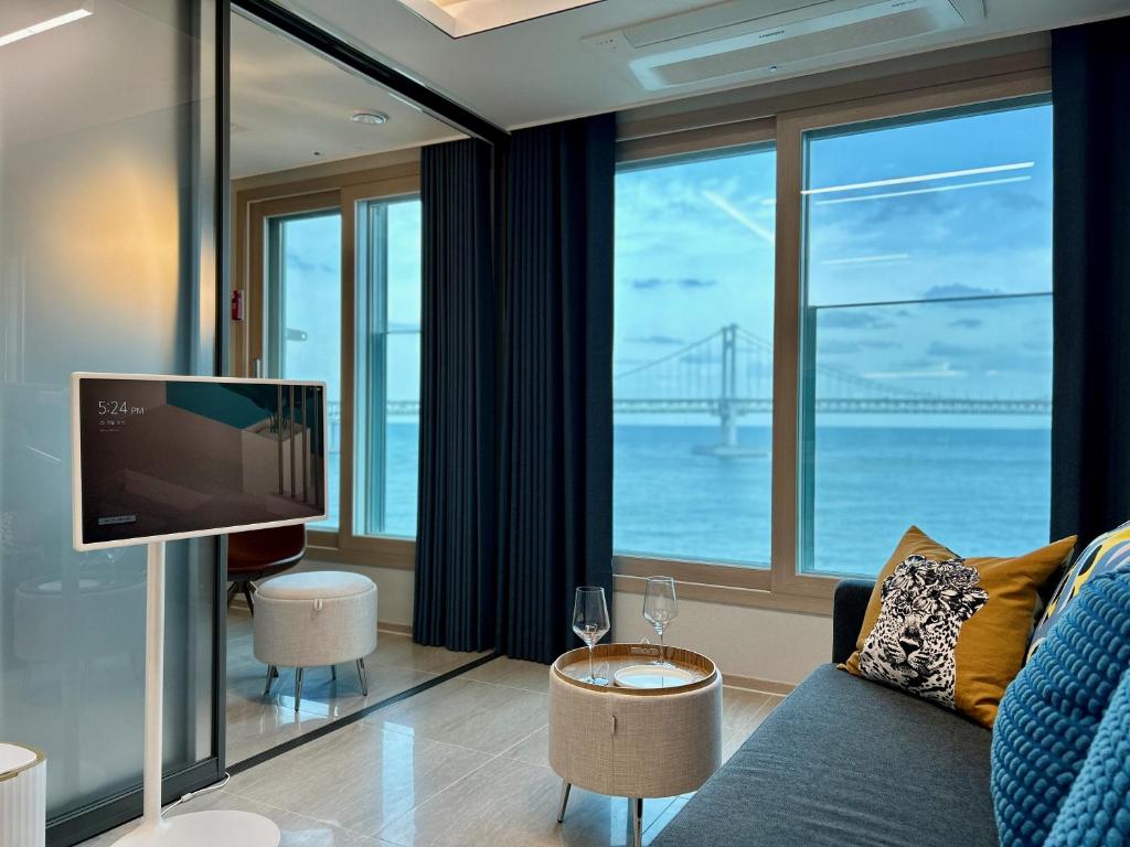 a living room with a view of the golden gate bridge at Ocean Front Apartment in Busan