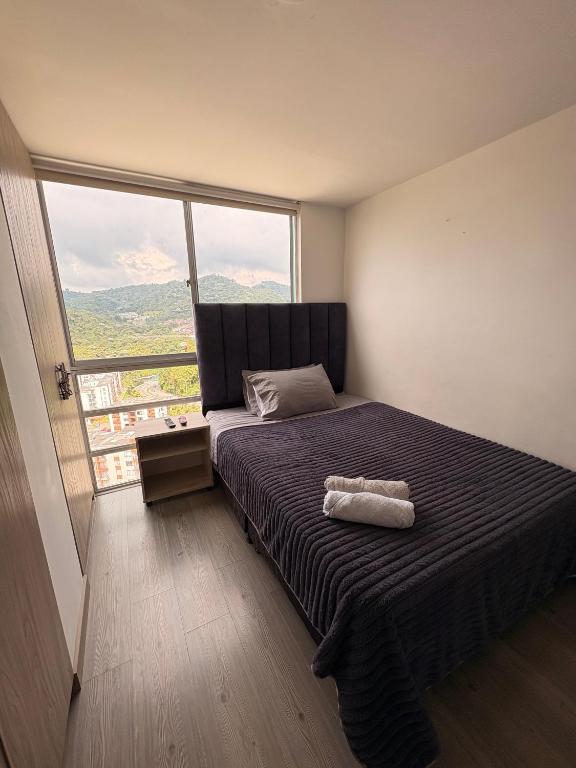Ένα ή περισσότερα κρεβάτια σε δωμάτιο στο Apartamento Urban Manizales Acogedor
