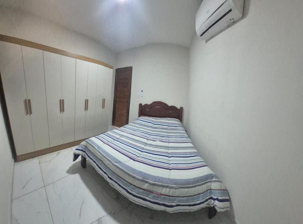 a bedroom with a bed in the corner of a room at Barra do Cunhaú - Barra Mar in Canguaretama