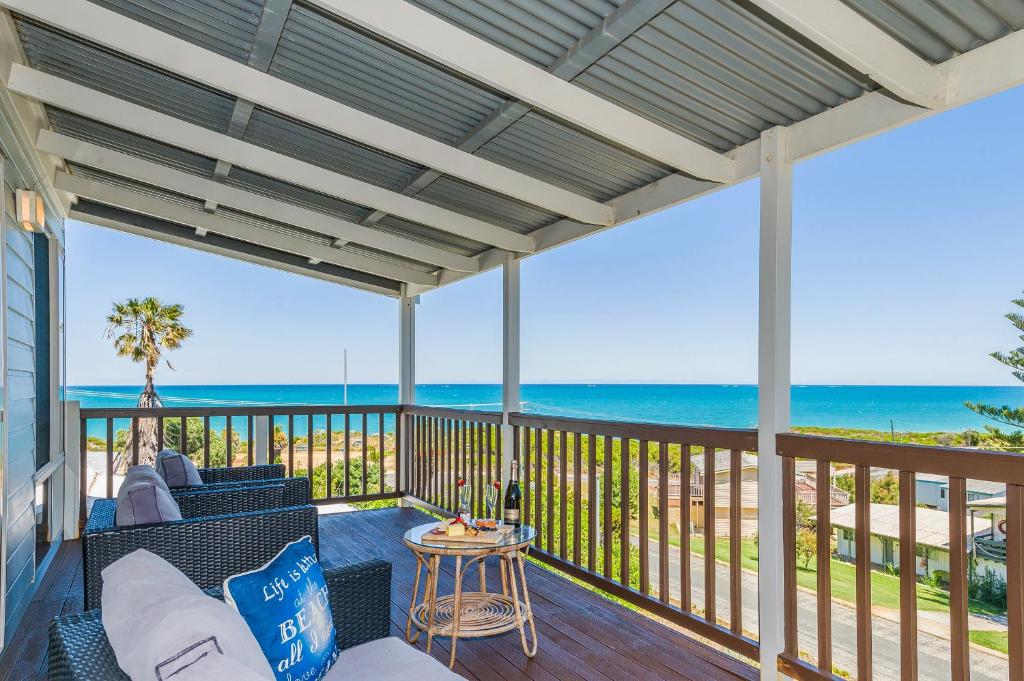 a screened porch with a view of the ocean at Ocean Vista Large Modern Home With Ocean Views in Guilderton