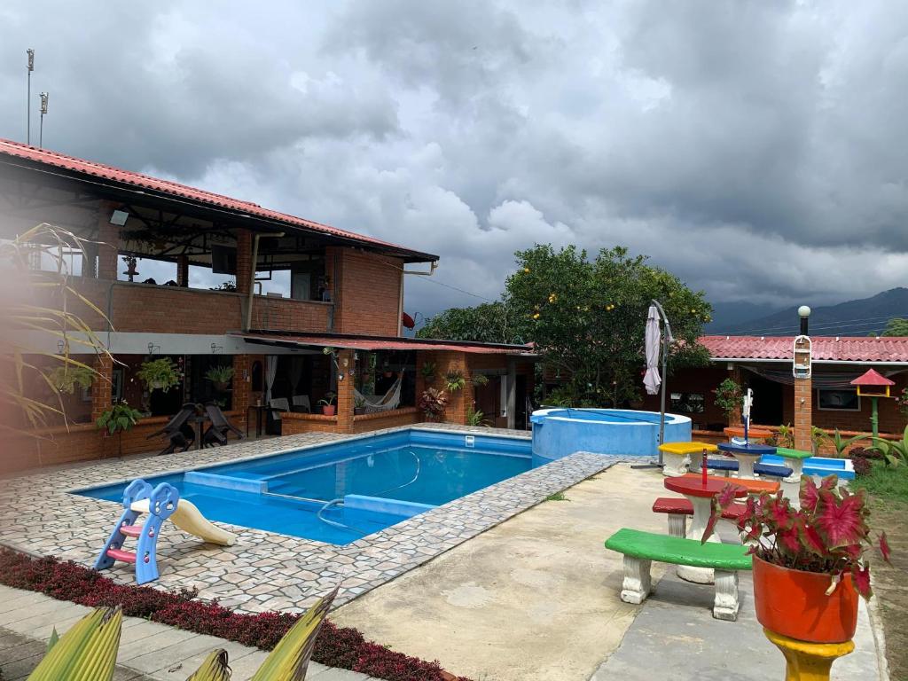 a swimming pool in the backyard of a house at Villa Pospon in Buga