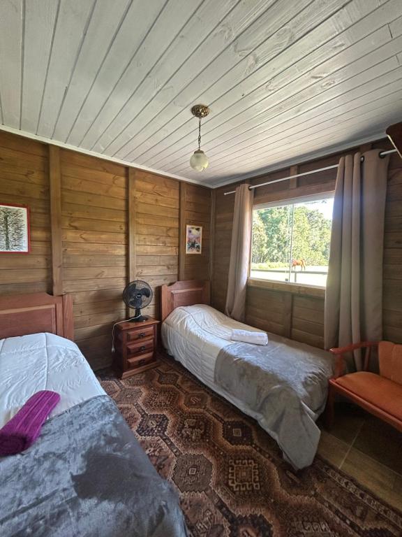 Una cama o camas en una habitación de Chalé Solar das Hortênsias