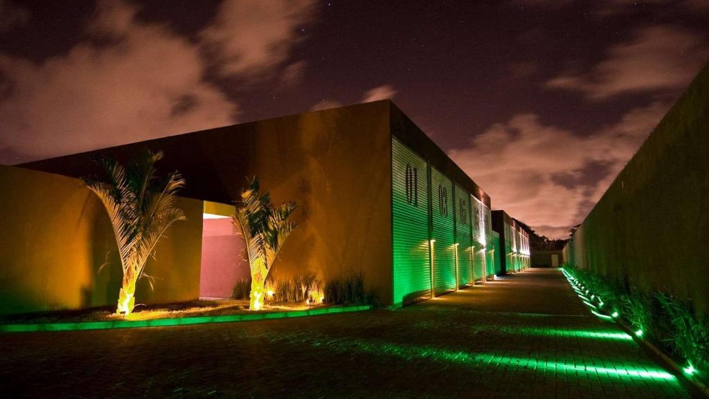 a building with green lights on it at night at Sensacional Suíte no Union no Jacaré! in Ilha da Restinga