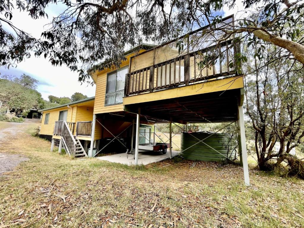 a house with a balcony on top of it at Condon 53 in Evergreen