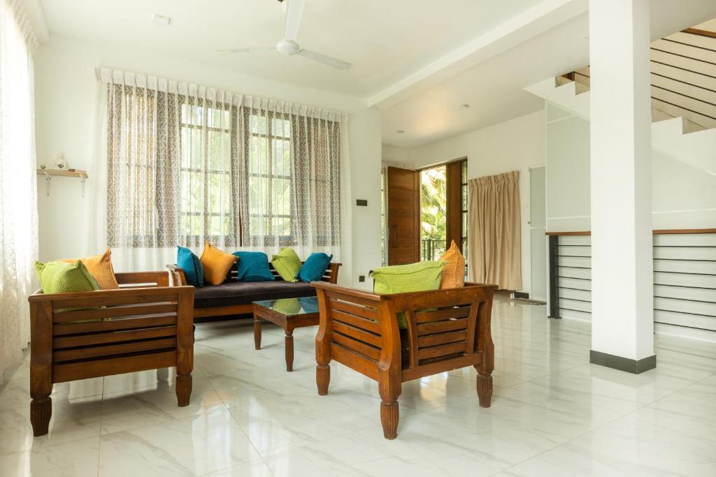a living room with a couch and chairs at Ivy Garden Retreat in Gampola