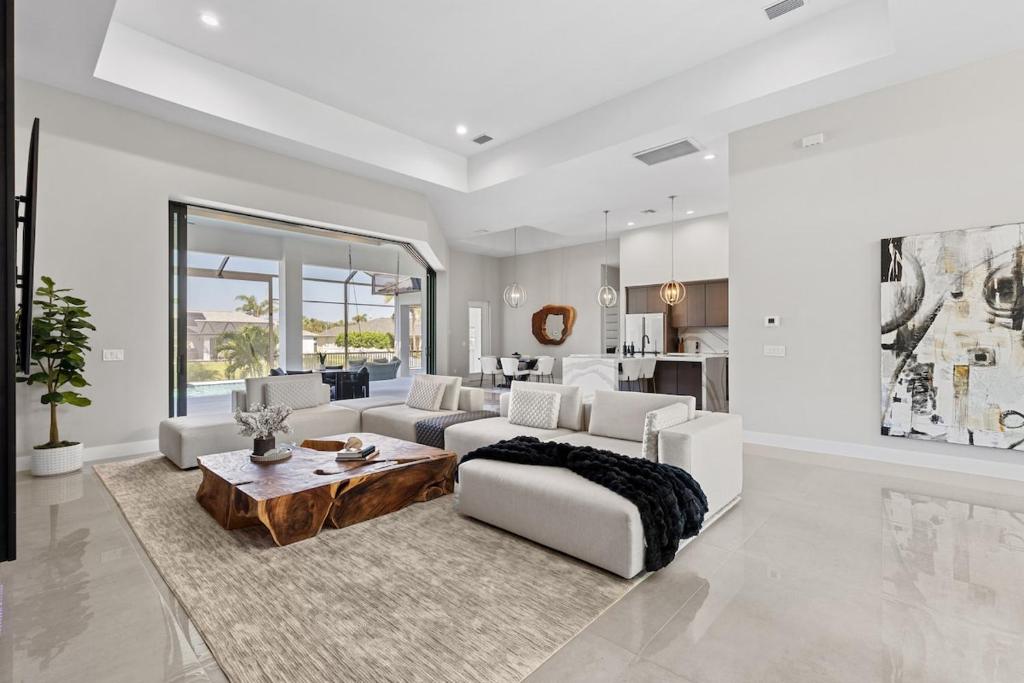a living room with a couch and a table at Modern Luxury Oasis Pool and Dock in Cape Coral