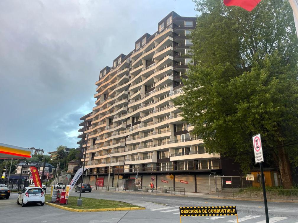een groot gebouw met een auto ervoor geparkeerd bij Puerto Montt Centro - Diagonal Germania in Puerto Montt