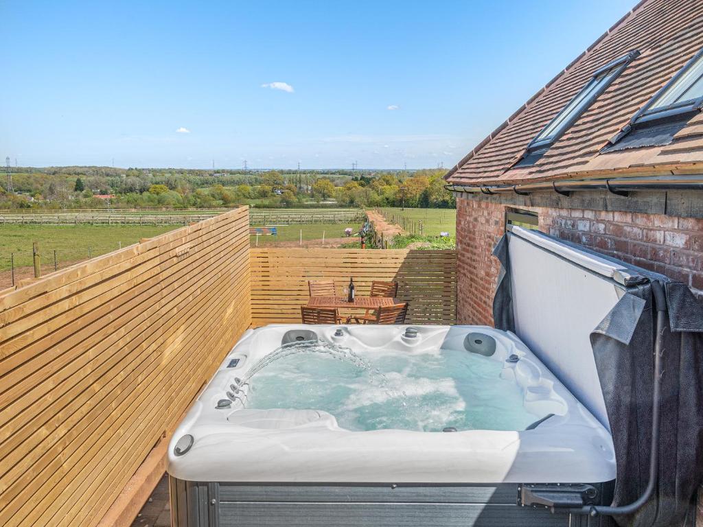 a hot tub sitting on the deck of a house at Corley Rocks Barn - Uk45939 in Corley
