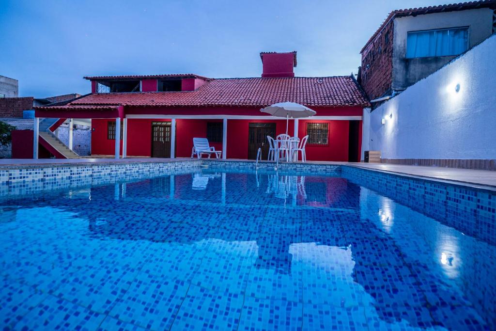 a swimming pool in front of a house at Casa a 950 m da Praia de Jauá - Espaçosa e Aconchegante! in Camaçari