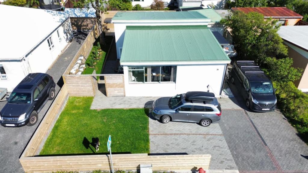 an aerial view of a house with cars parked in a yard at Ary & Pablo Airport Stay in Keflavík