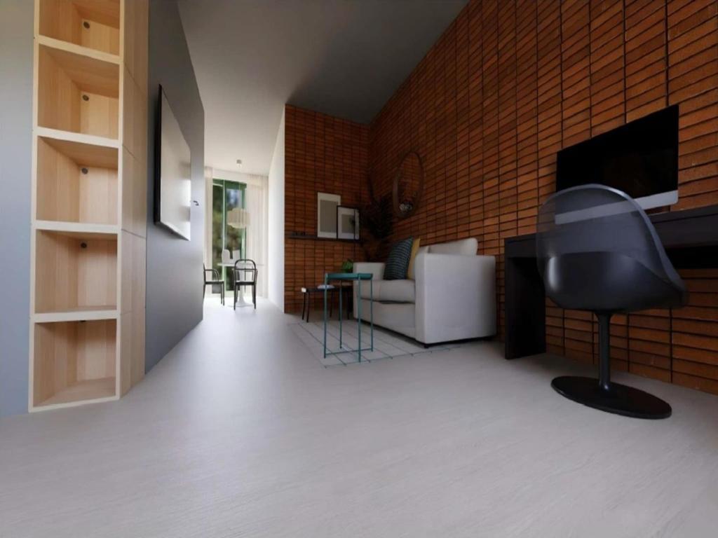 a living room with a couch and a television at Modern apartment in Bree with parking in Mellet