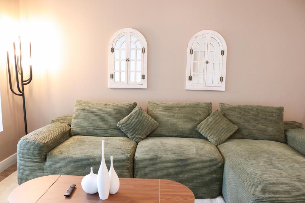 a living room with a couch and a table at Pacific Paradise 10 Min from Disneyland With Pool & GYM in Tustin