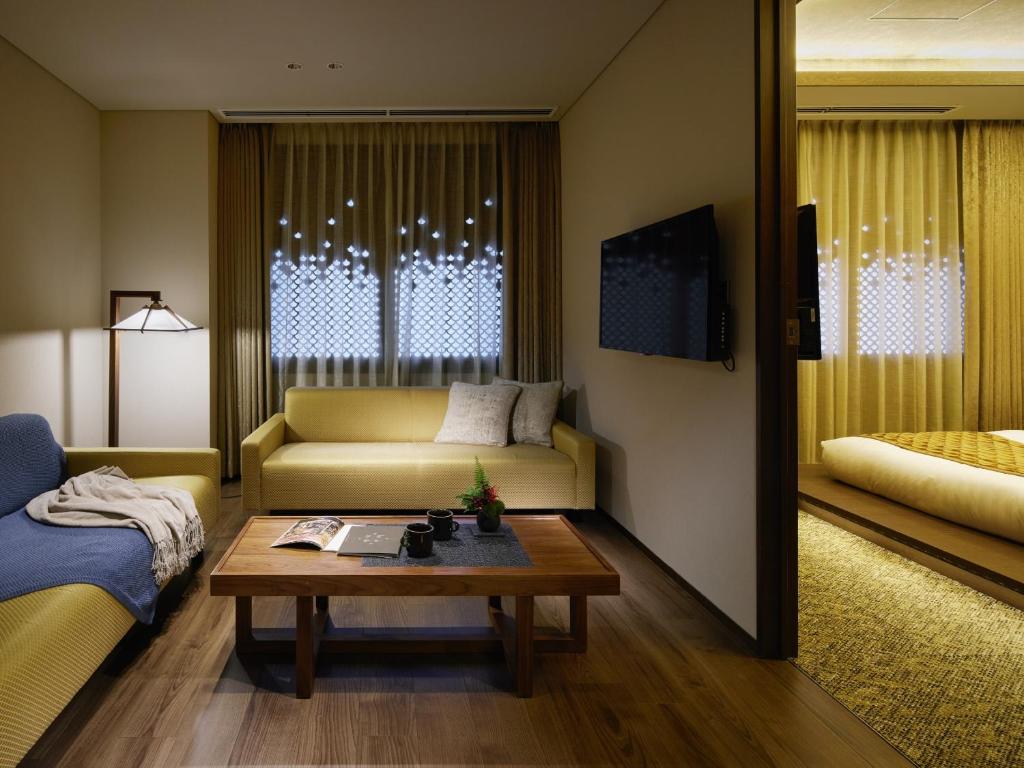 a living room with a couch and a coffee table at Minn Kanazawa in Kanazawa