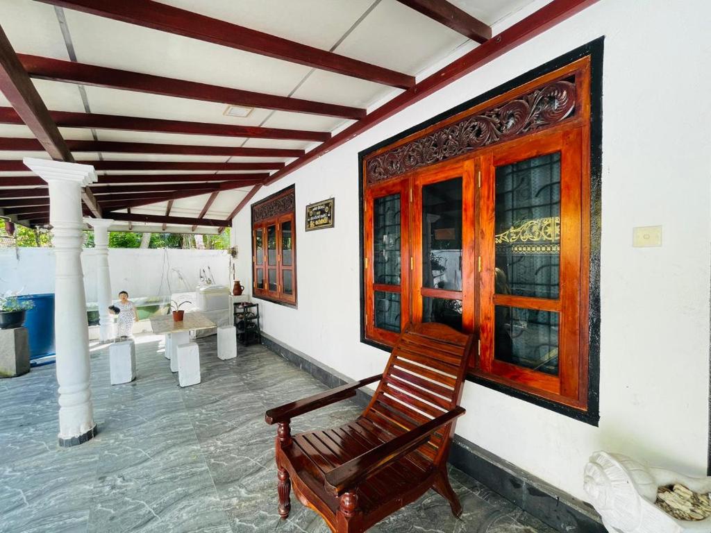 a rocking chair sitting on the porch of a house at Dhana Breeze in Weligama