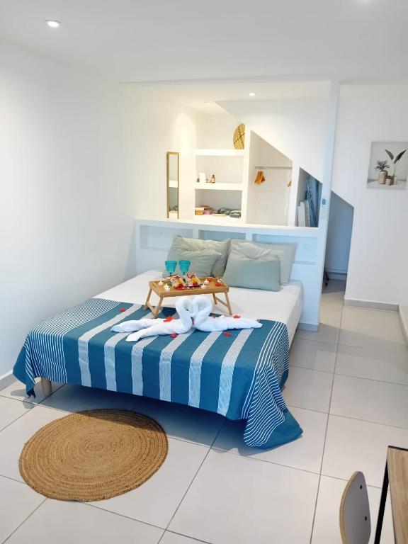 a bedroom with a bed with a tray on it at Cosy lodge in Goyave