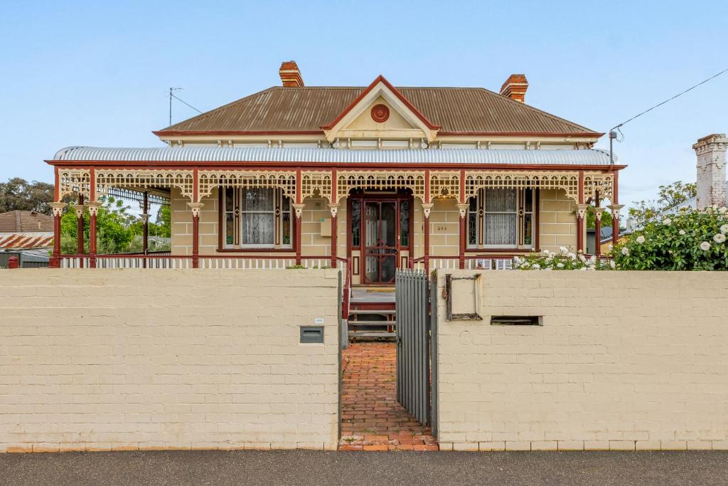 a house with a white fence in front of it at Cathedral View - Sleeps 16 in Bendigo