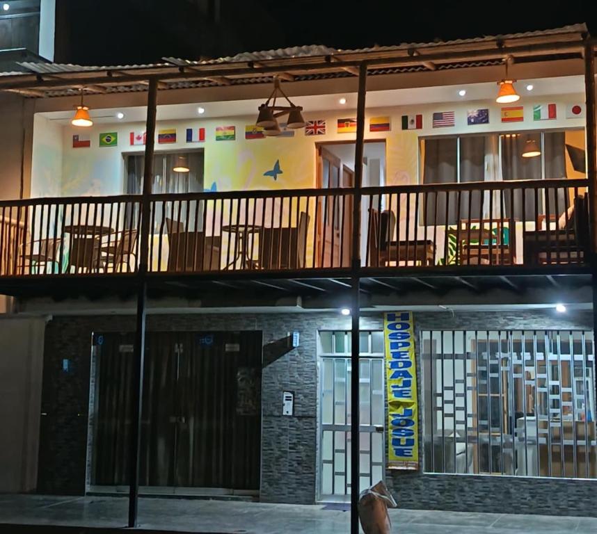 a building with tables and chairs on a balcony at HOSPEDAJE JOSUE - paracas in Paracas