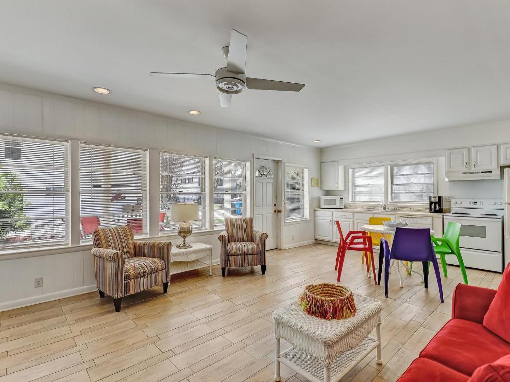 a living room with a red couch and chairs at Coops Retreat Unit B in Tybee Island
