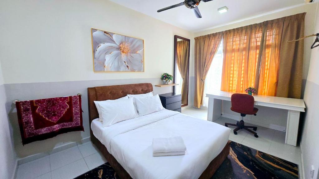 a bedroom with a bed and a desk and a computer at Homestay BAYT AL - JAZMY in Kuantan