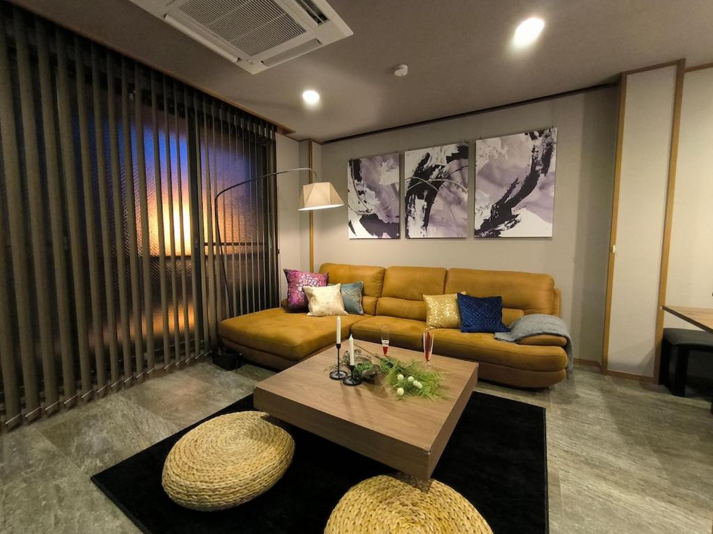ein Wohnzimmer mit Sofa und Tisch in der Unterkunft simasima-stay高松駅 ー 高松駅徒歩2分 無料駐車場ー in Takamatsu