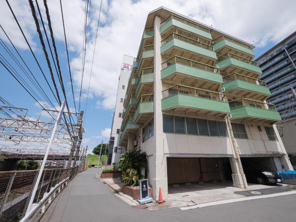 a building under construction on a city street at 泊るHouse千葉駅1分 J - 東京ディズニーランドまで30分 線路傍騒音あり in Chiba