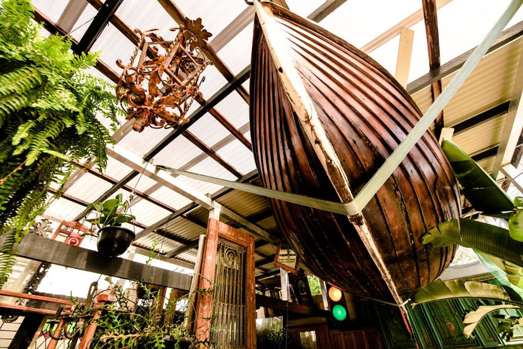a large wooden boat hanging from the ceiling of a building at Loft Apartment - 1 Bedroom in Brunswick Heads
