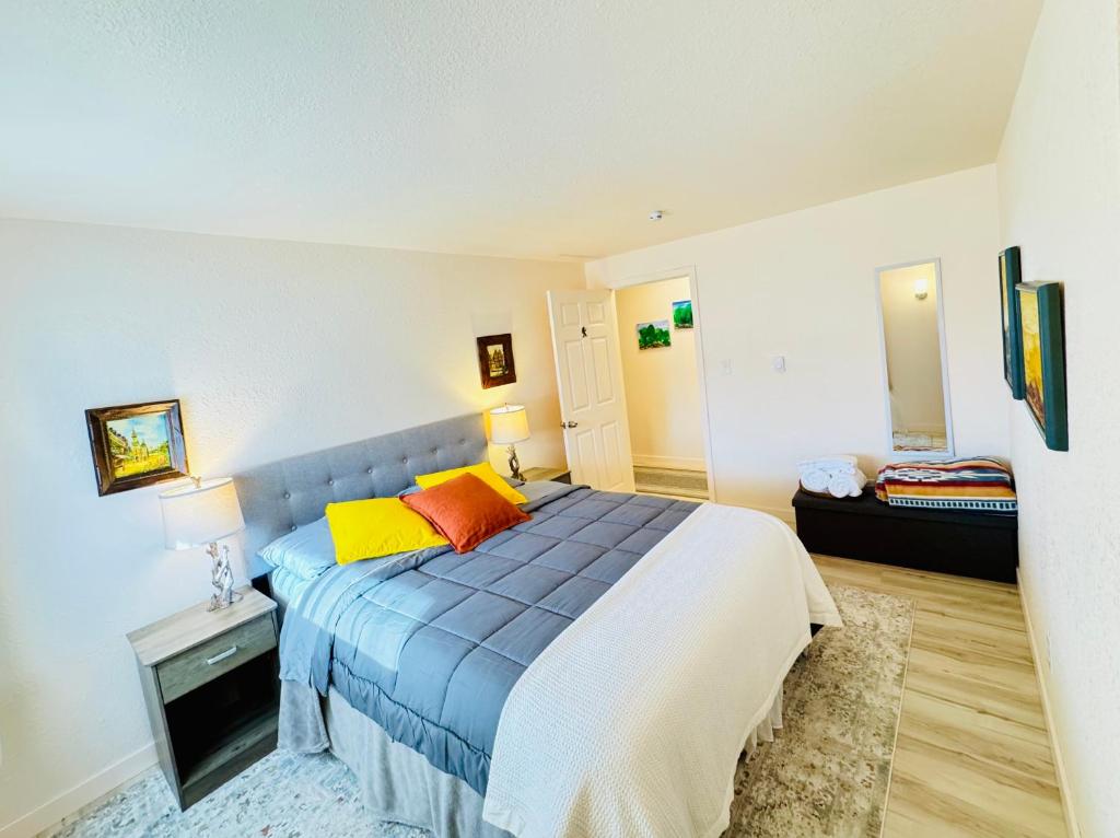 a bedroom with a blue bed and a couch at Fishermens paradise in Forks