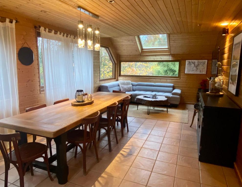 a living room with a wooden table and a couch at Appartement - Chalet MONT DORE COSY 6/7 personnes in Le Mont-Dore