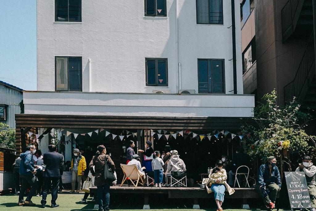 a group of people standing outside of a building at のあそびlodge in Arao