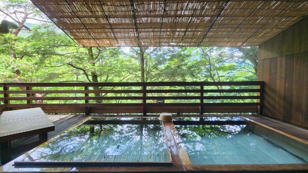 a swimming pool in a house with a fence at Hotel Manyotei in Nikko