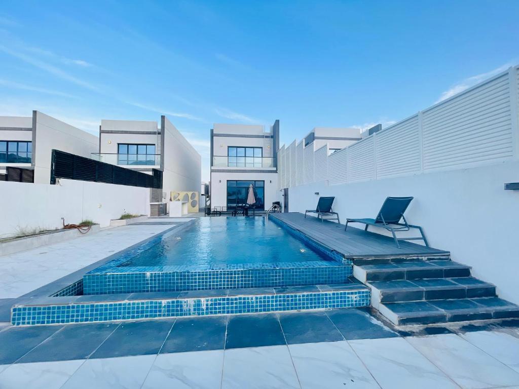 a swimming pool in the middle of a house at 3BR villa and maid room by escape time in Sharm