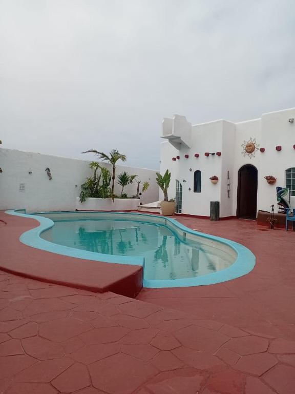 a swimming pool in the middle of a patio at Exotic Oceanfront villa with Private Pool & jacuzzi - Parties & Events in Rosarito