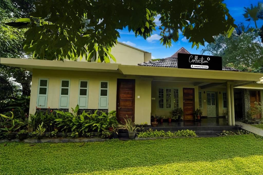 a building with a sign on top of it at Super Collection O Chalakkudy River Annamanada Formerly Svasthya Retreat in Māla