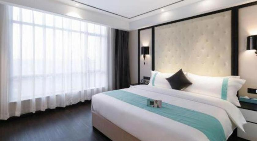 Ένα ή περισσότερα κρεβάτια σε δωμάτιο στο Xana Hotelle· Dongguang Chang'An Binhaiwan Jian'An Road