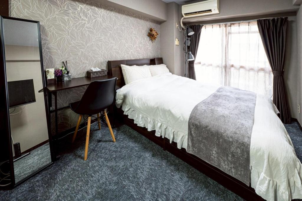 Postel nebo postele na pokoji v ubytování メトロ春日203