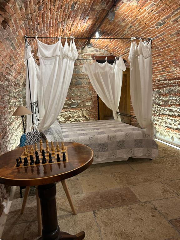 a bedroom with a chess board on a table and a bed at Taverna La Torre in Bassano del Grappa