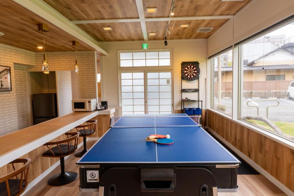 a ping pong table in the middle of a room at Kiwaya 貴和家 - Fuji Numazu BASE - in Numazu