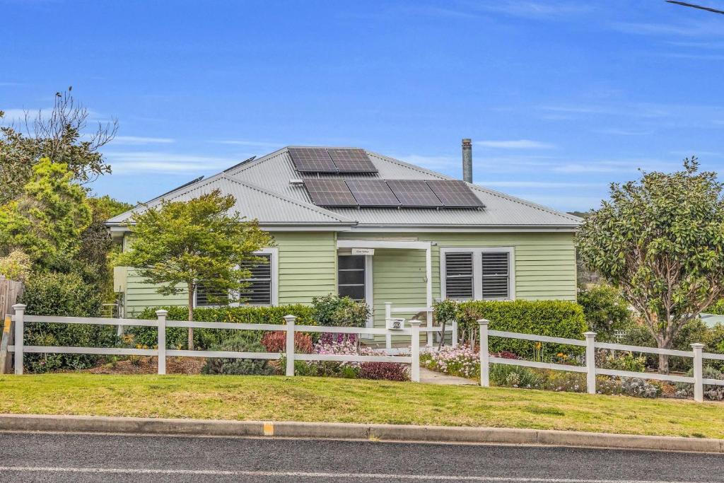 a green house with solar panels on the roof at Murrah Street, 40 in Bermagui